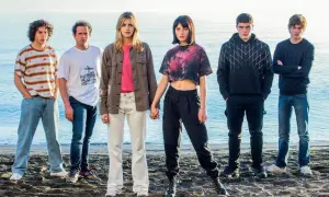 Il cast di Baby posa sulla spiaggia, con il mare sullo sfondo.