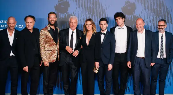 Il cast di Suburra - La serie posa sul red carpet. Un gruppo di attori e attrici, tra cui Alessandro Borghi e Giacomo Ferrara, sorridono alla fotocamera.