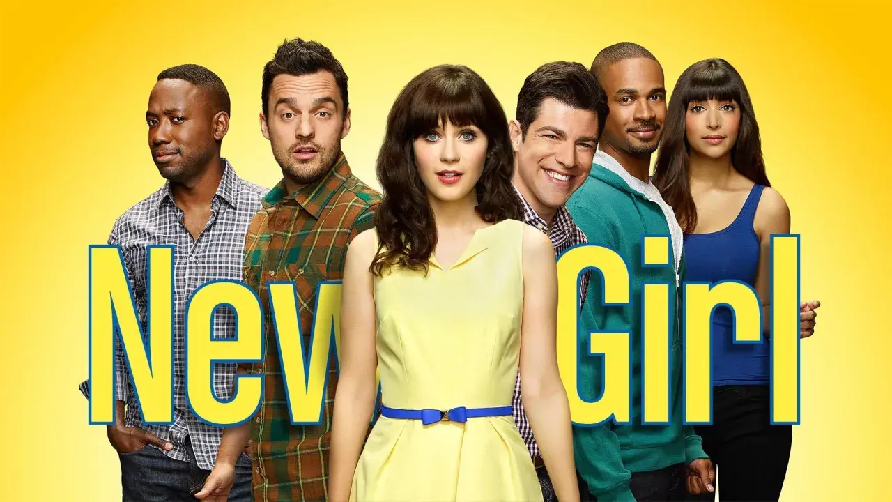 Il cast di New Girl, con Jess al centro in giallo, circondata dai suoi amici.
