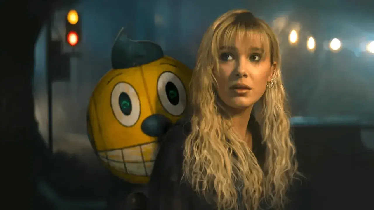 Ragazza bionda con un personaggio giallo dietro, in un'atmosfera cupa. Sembrano in uno stato elettrico di tensione.