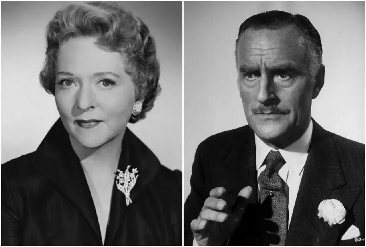 Il cast di "Caccia al ladro": Grace Kelly elegante con spilla floreale e Cary Grant con baffi e fiore all'occhiello.