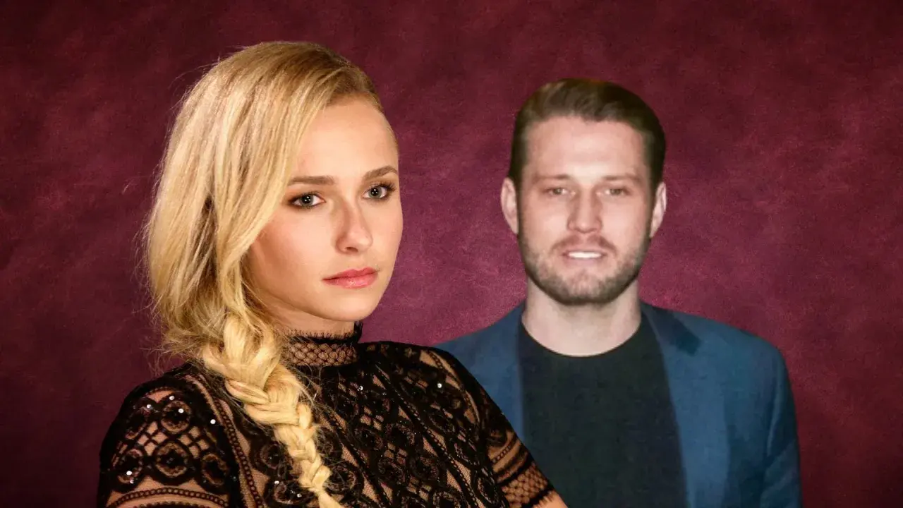 Hayden Panettiere oggi, con un uomo sullo sfondo. Lei indossa un abito di pizzo nero.